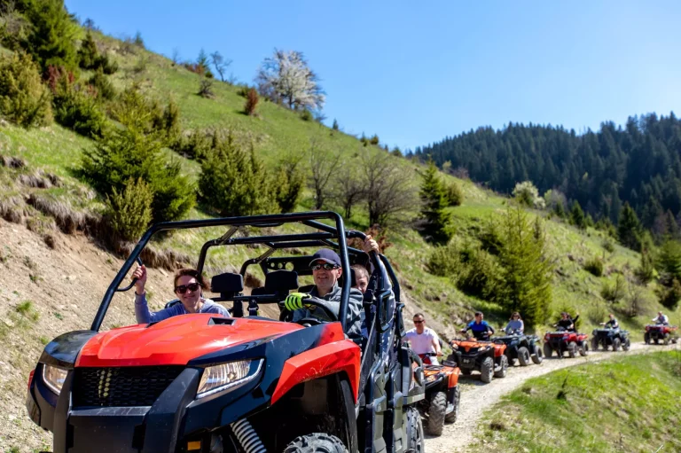 Un gruppo di turisti viaggia su ATV e UTV in montagna